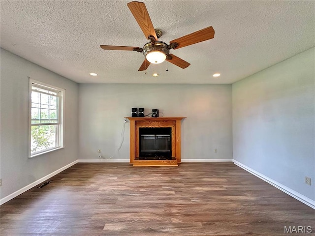 6624 State Route C, Saint Genevieve, MO 63670 - unfurnished living room featuring recessed lighting, wood finished floors, a textured ceiling, a glass covered fireplace, and a ceiling fan
