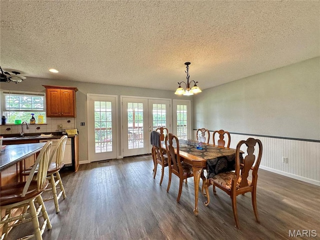 6624 State Route C, Saint Genevieve, MO 63670 - dining area featuring a textured ceiling, a chandelier, dark wood-style flooring, plenty of natural light, and french doors