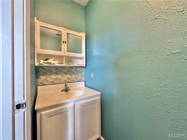 6624 State Route C, Saint Genevieve, MO 63670 - bathroom featuring tasteful backsplash, vanity, and a textured wall