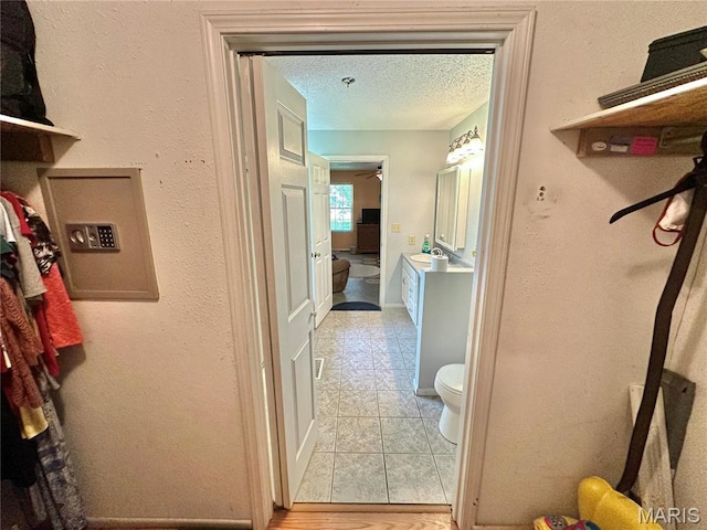 6624 State Route C, Saint Genevieve, MO 63670 - hallway featuring a textured ceiling and light tile patterned flooring