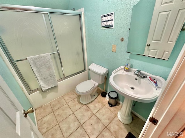 6624 State Route C, Saint Genevieve, MO 63670 - bathroom featuring combined bath / shower with glass door, tile patterned floors, and a textured wall