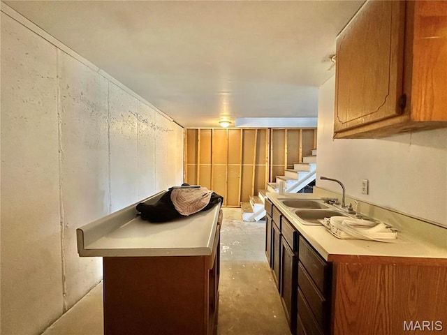 6624 State Route C, Saint Genevieve, MO 63670 - kitchen with concrete floors, light countertops, and brown cabinets