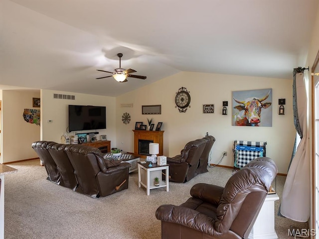 carpeted living area featuring vaulted ceiling, a ceiling fan, and baseboards