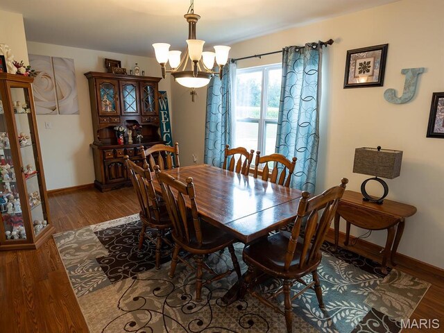 2700 Treetop Ln, Palmyra, MO 63461 - dining space with wood finished floors, a chandelier, and baseboards