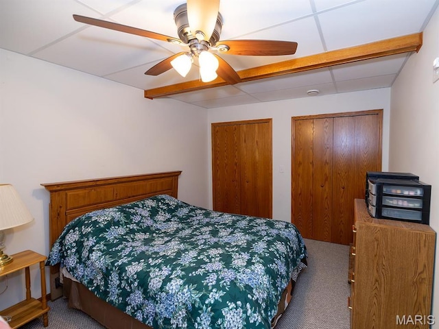 bedroom featuring carpet, multiple closets, and ceiling fan