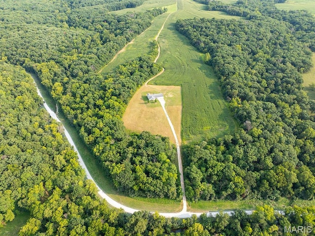 aerial view of property and surrounding area with a forest, property boundaries highlighted, and rural landscape