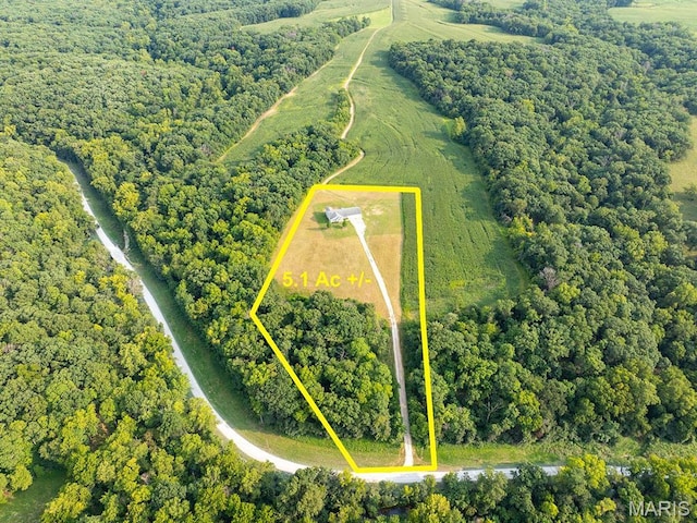 aerial overview of property's location featuring property parcel outlined and a forest