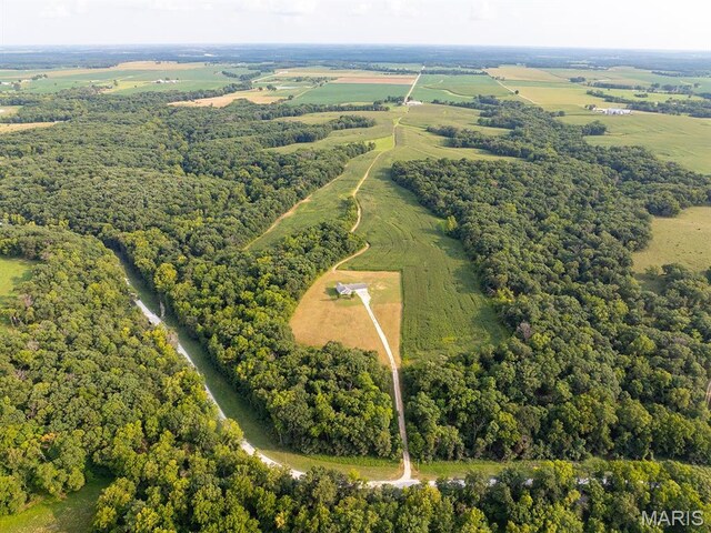 aerial view of property's location featuring rural landscape and a forest