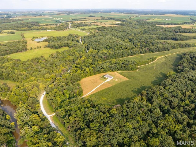 aerial overview of property's location with a heavily wooded area