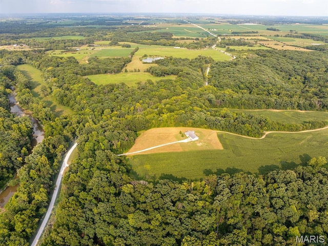 aerial view of property and surrounding area with a forest
