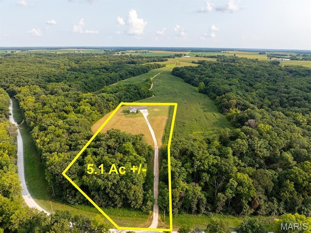 aerial view of property's location featuring property parcel outlined and a forest