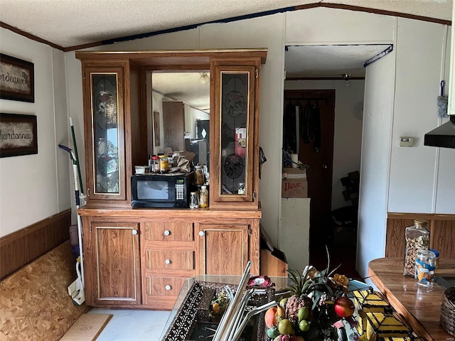 1334 Beverly Blvd, Park Hills, MO 63601 - dining space featuring wainscoting, crown molding, a textured ceiling, and wood walls