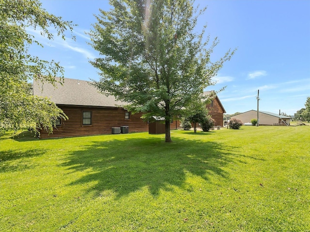 view of green lawn featuring central AC unit