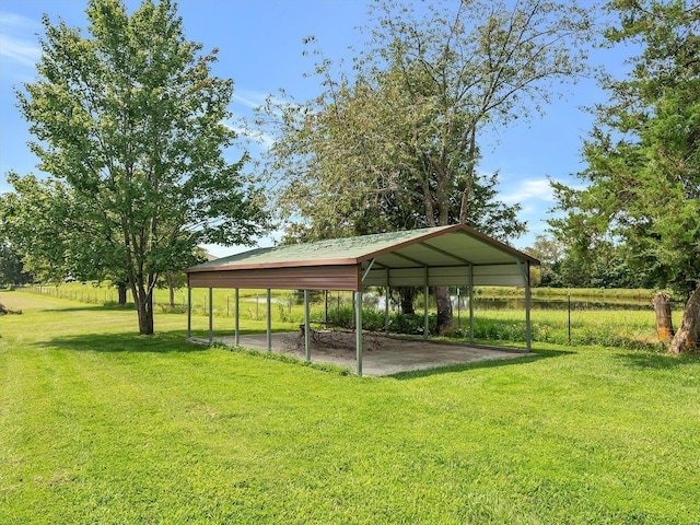 view of green lawn with a detached carport