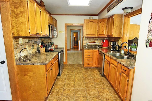kitchen with appliances with stainless steel finishes, a sink, decorative backsplash, brown cabinets, and crown molding
