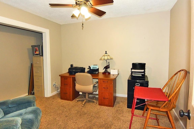 office space featuring a ceiling fan, carpet floors, and baseboards