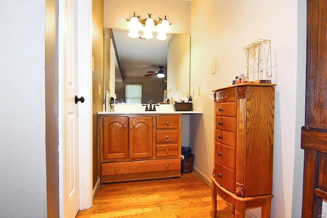 bathroom with wood finished floors, vanity, and ceiling fan