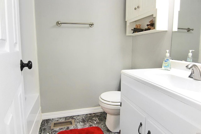 bathroom featuring baseboards, toilet, and vanity