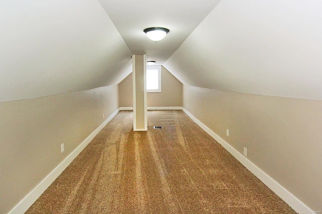 additional living space featuring carpet floors, lofted ceiling, and baseboards