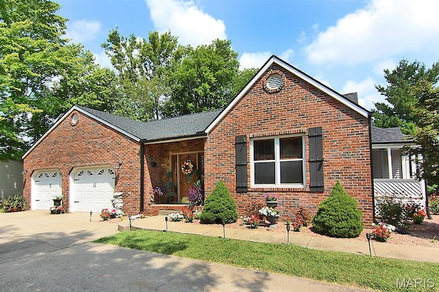 2110 Bainbridge Rd, Jackson, MO 63755 - view of front of house with brick siding, concrete driveway, a garage, and a shingled roof