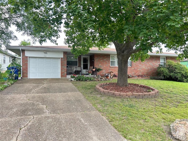 102 W Center St, Salem, MO 65560 - single story home featuring a garage, a front yard, driveway, covered porch, and brick siding