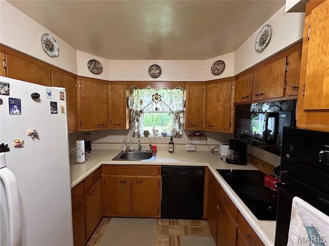102 W Center St, Salem, MO 65560 - kitchen with black appliances, a sink, brown cabinets, and light countertops