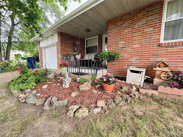 102 W Center St, Salem, MO 65560 - view of side of property with covered porch, brick siding, and an attached garage