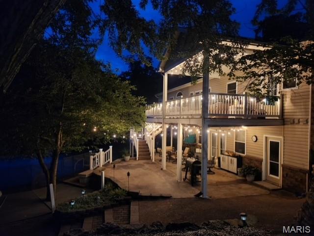 970 Lammert Ln, Union, MO 63084 - back of house at night featuring a patio area, stairway, and a deck
