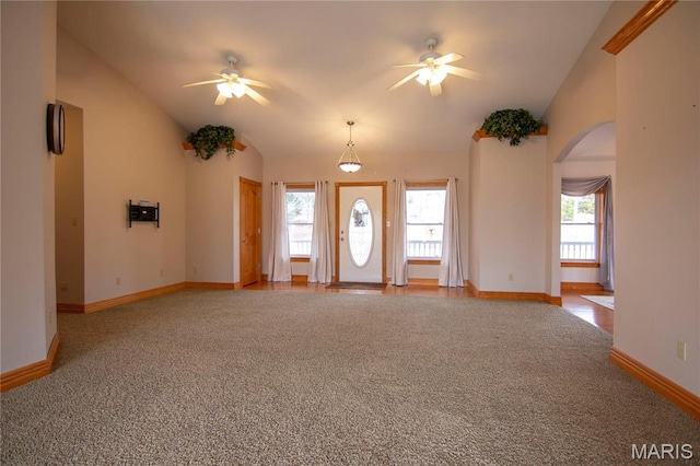 970 Lammert Ln, Union, MO 63084 - unfurnished living room featuring ceiling fan, carpet, arched walkways, vaulted ceiling, and baseboards
