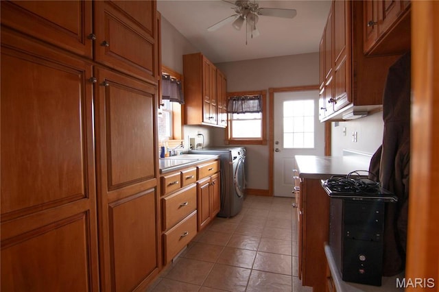 970 Lammert Ln, Union, MO 63084 - kitchen featuring ceiling fan, brown cabinetry, independent washer and dryer, and light tile patterned floors