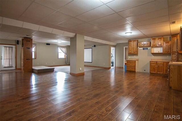 970 Lammert Ln, Union, MO 63084 - unfurnished living room featuring dark wood-style flooring, baseboards, a drop ceiling, and a sink