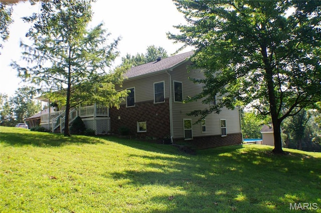 970 Lammert Ln, Union, MO 63084 - view of side of home featuring a lawn, brick siding, and stairway