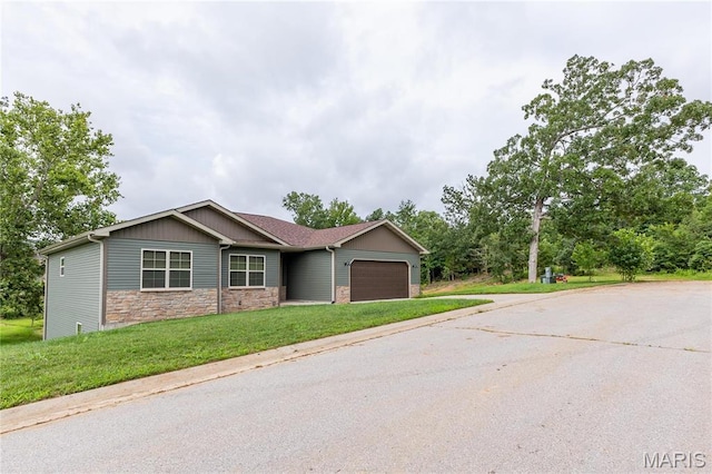 129 Jared St, Waynesville, MO 65583 - view of front of property with a garage, stone siding, driveway, a front yard, and board and batten siding