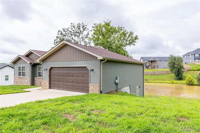 129 Jared St, Waynesville, MO 65583 - view of front of property featuring a front lawn, a garage, board and batten siding, and driveway