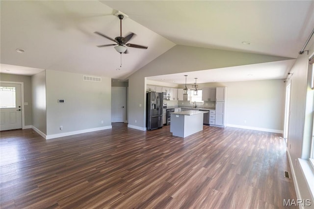 129 Jared St, Waynesville, MO 65583 - unfurnished living room with lofted ceiling, a ceiling fan, healthy amount of natural light, and dark wood-type flooring