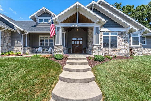 128 Jared St, Waynesville, MO 65583 - craftsman inspired home featuring stone siding, a front lawn, covered porch, and a shingled roof