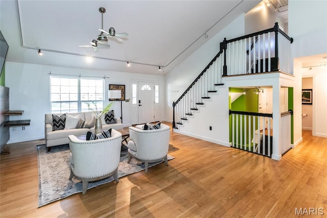 1010 Winter Lake Dr, Fenton, MO 63026 - living room with track lighting, wood finished floors, a ceiling fan, and stairs