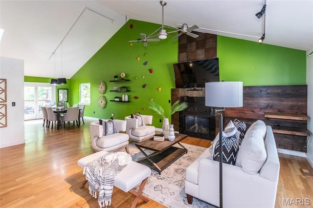 1010 Winter Lake Dr, Fenton, MO 63026 - living area with track lighting, ceiling fan, high vaulted ceiling, a large fireplace, and wood finished floors