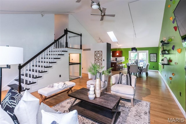 1010 Winter Lake Dr, Fenton, MO 63026 - living room with ceiling fan, wood finished floors, high vaulted ceiling, a skylight, and stairway
