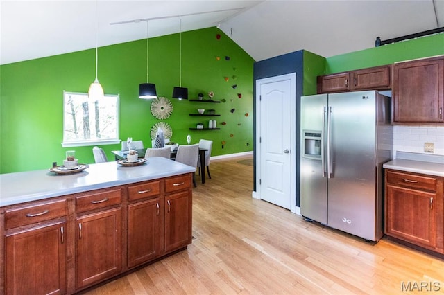 1010 Winter Lake Dr, Fenton, MO 63026 - kitchen featuring stainless steel fridge, light countertops, high vaulted ceiling, light wood-style floors, and pendant lighting