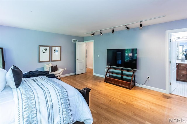 1010 Winter Lake Dr, Fenton, MO 63026 - bedroom featuring rail lighting, wood finished floors, and baseboards