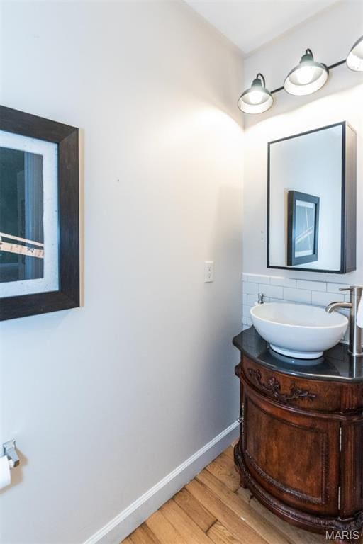 1010 Winter Lake Dr, Fenton, MO 63026 - bathroom featuring wood finished floors, baseboards, vanity, and tasteful backsplash