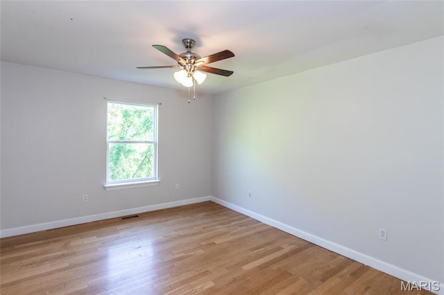 1010 Winter Lake Dr, Fenton, MO 63026 - empty room with baseboards, ceiling fan, and light wood-style flooring