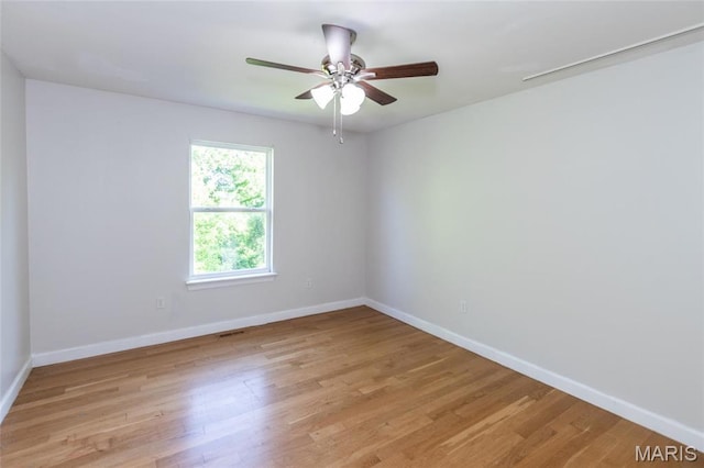 1010 Winter Lake Dr, Fenton, MO 63026 - unfurnished room with baseboards, light wood-type flooring, and a ceiling fan