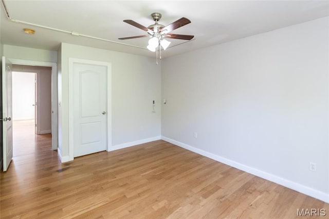 1010 Winter Lake Dr, Fenton, MO 63026 - spare room featuring baseboards, a ceiling fan, light wood-style flooring, and a smoke detector
