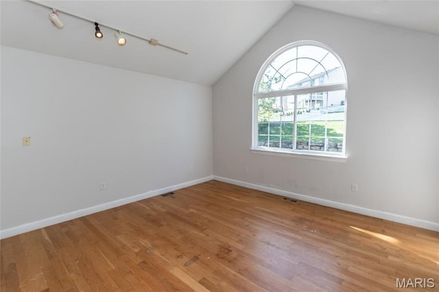 1010 Winter Lake Dr, Fenton, MO 63026 - empty room with lofted ceiling, wood finished floors, baseboards, and rail lighting