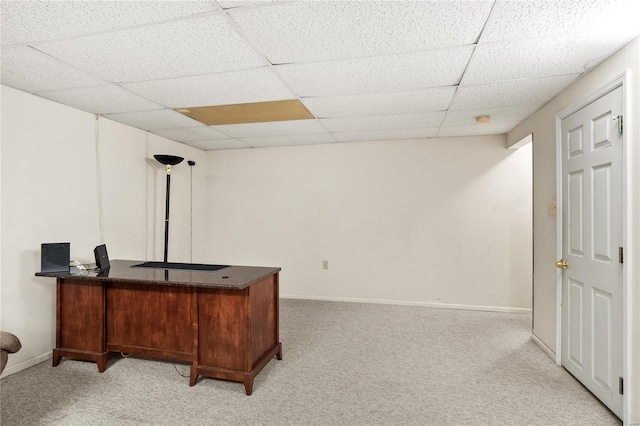 office featuring light carpet, a paneled ceiling, and baseboards