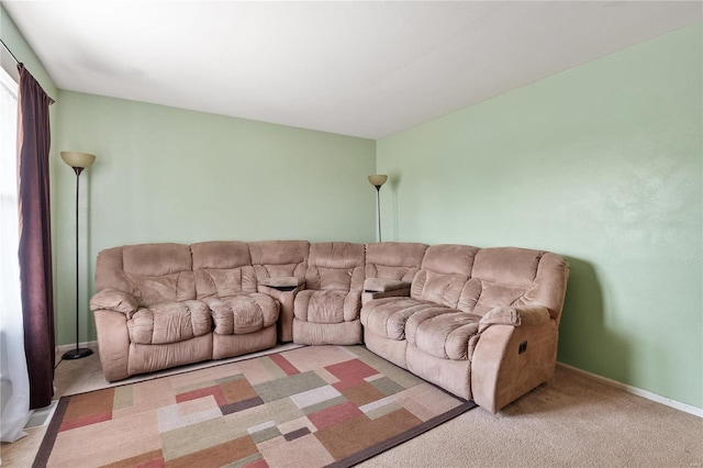 carpeted living room with baseboards