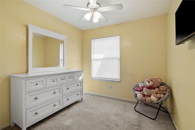 bedroom featuring light carpet, baseboards, and a ceiling fan