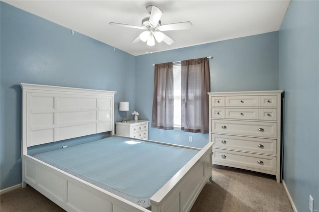 bedroom with dark colored carpet, baseboards, and ceiling fan